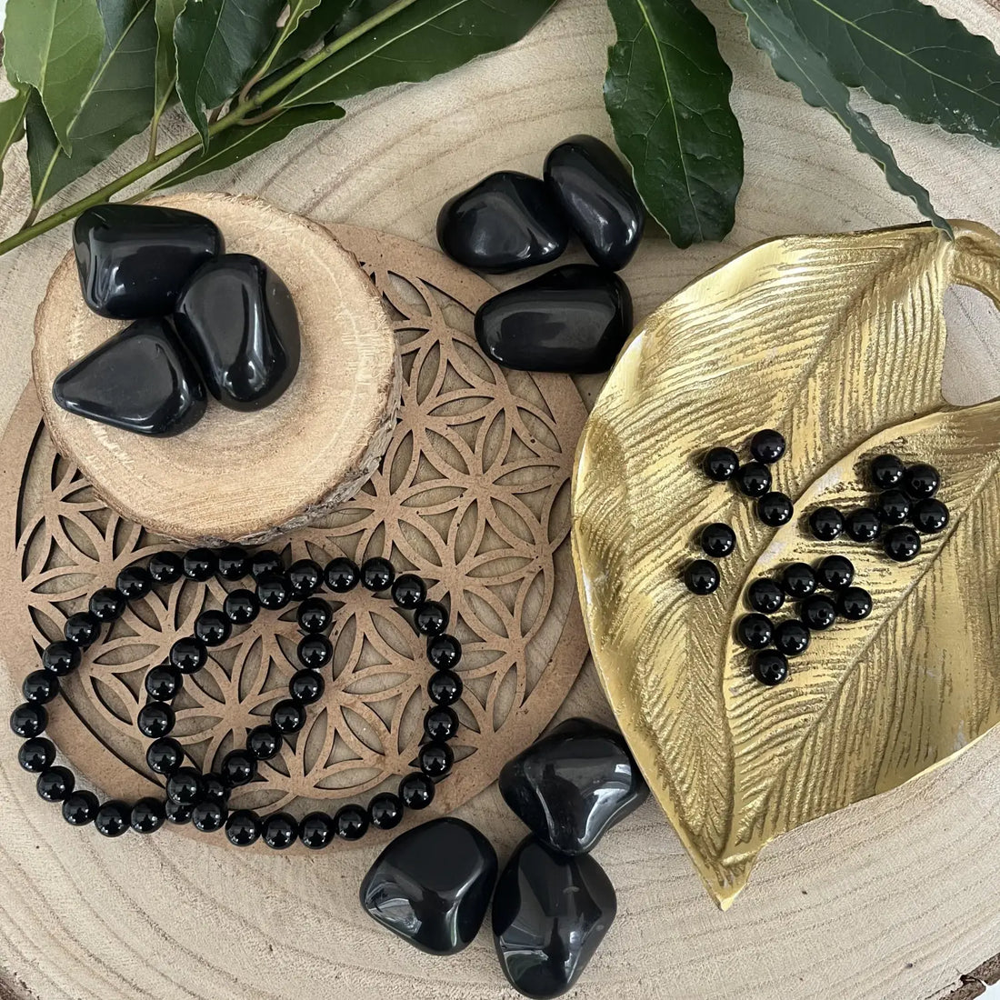 Collection de Pierre Onyx Naturelle sur un plateau avec des perles, favorisant la protection et la sérénité