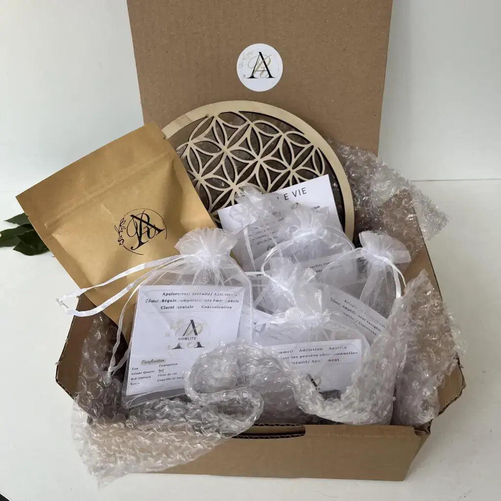 Kit Découverte Lithothérapie Aura de Roche boîte ouverte avec pierres en sachets organza et fleur de vie