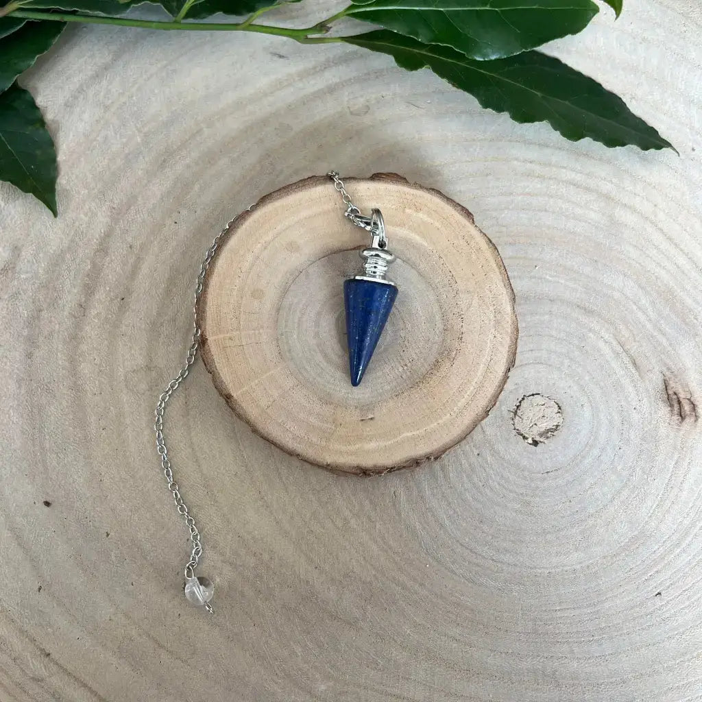 Pendule en Lapis Lazuli suspendu sur un support en bois, idéal pour la divination et la méditation